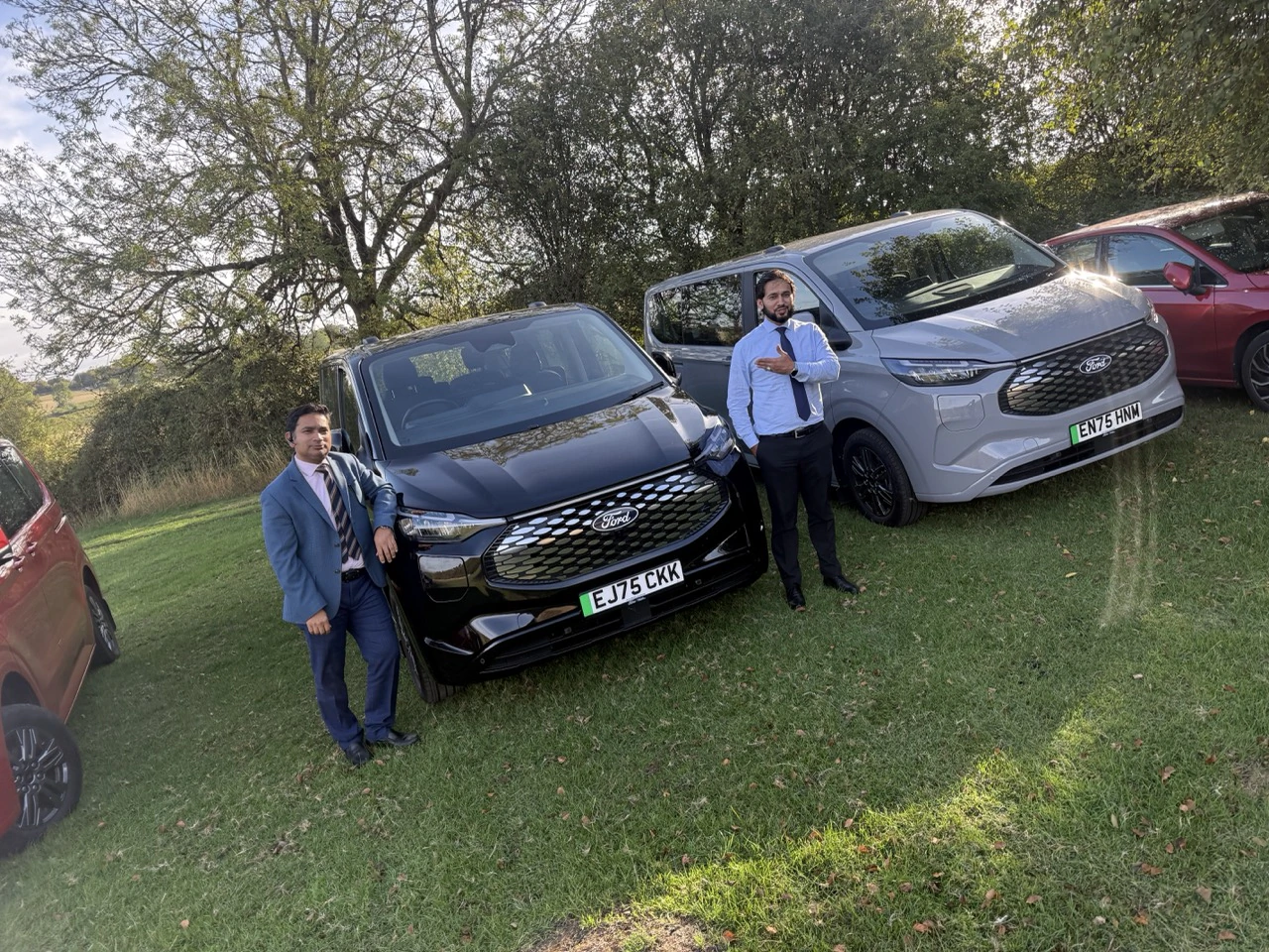 PTG chauffeurs with black and silver Ford Tourneo vehicles during a brand event